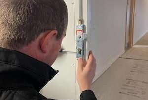 Locksmith completing a lock replacement on a door